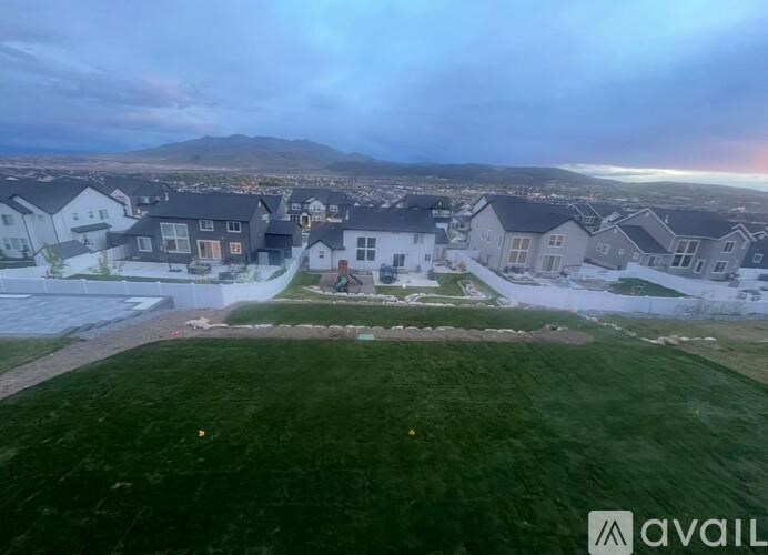 A bird's eye view of a residential area with houses and a green lawn.