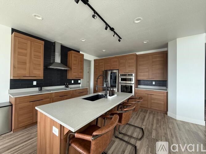 A kitchen with wooden cabinets and a large island.