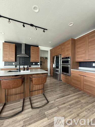 A kitchen with wooden cabinets and a white countertop.