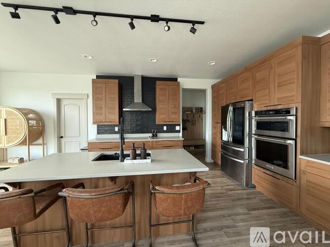 A kitchen with wooden cabinets and a large island.