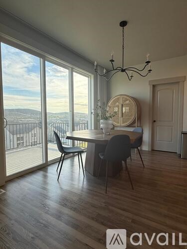 A dining room with a table set for four and a view of the city.