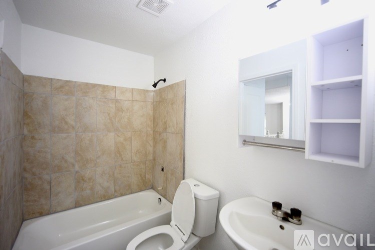 A staircase with a white railing and wooden steps leading to a white door.