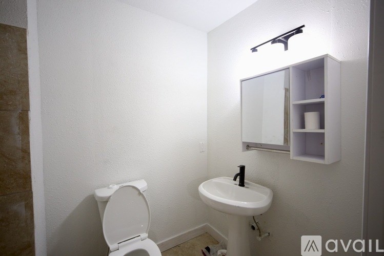 A room with a ceiling fan and wooden flooring.