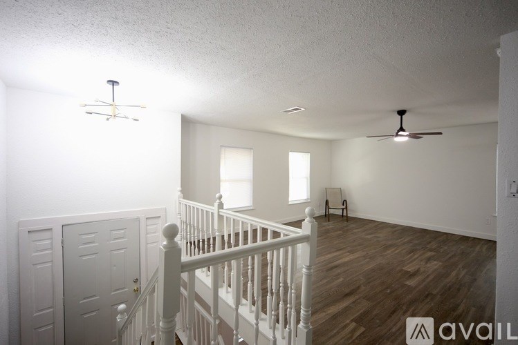 A room with a window and wooden flooring.