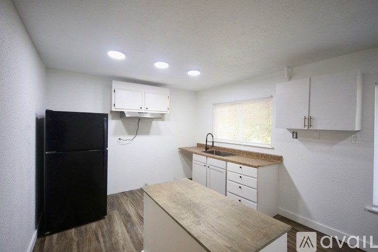 A white staircase with a balustrade and a door at the bottom.