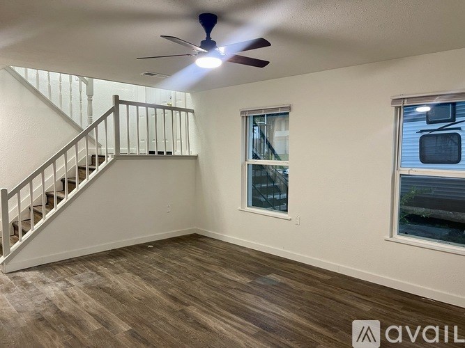 A room with a staircase and a window.