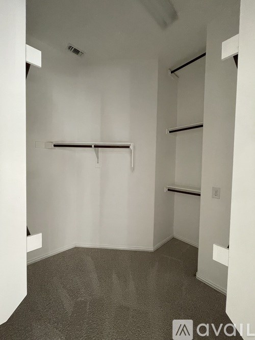 A room with a grey carpet and white walls.