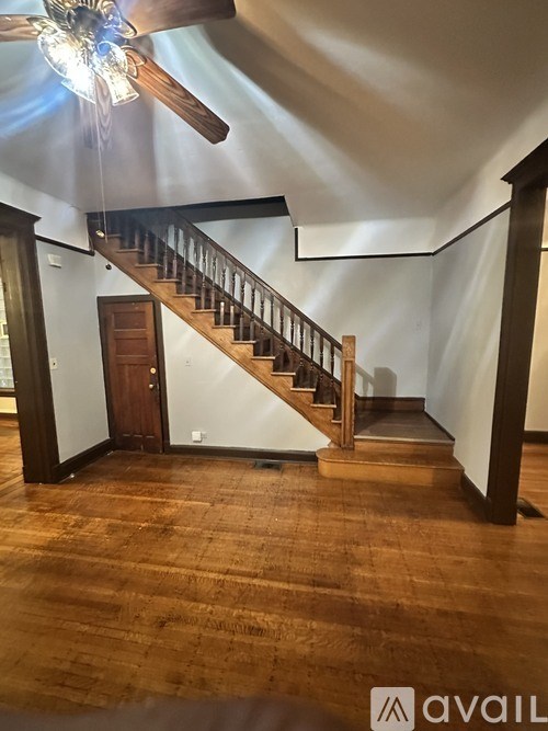 A wooden staircase with a light on the ceiling.