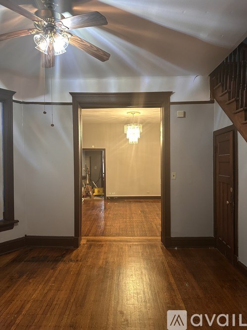 A room with a ceiling fan and a light fixture.