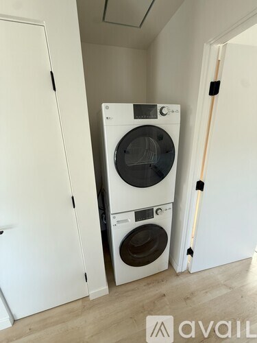 A white washing machine and dryer in a small room.