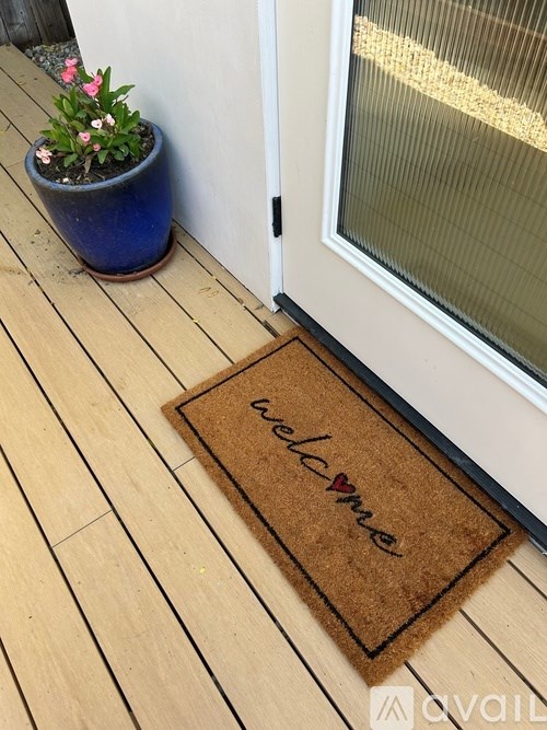 A brown doormat with the word "welcome" on it.