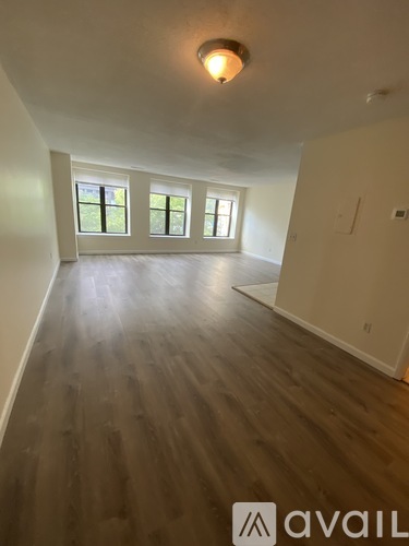A room with wooden floors and a window.