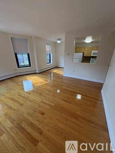 A room with wooden flooring and a window.