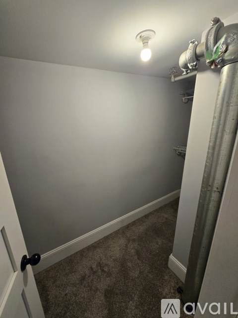 A room with a door and a light on the ceiling.