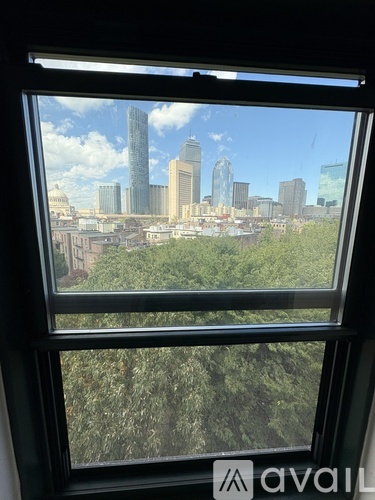 A window with a view of a city skyline.