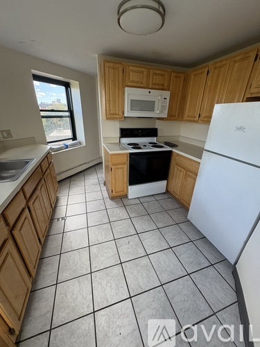 A kitchen with wooden cabinets and a white fridge.