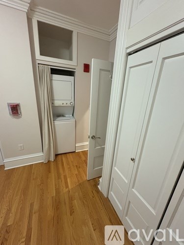 A kitchen with white cabinets and a white fridge with a white microwave above it.