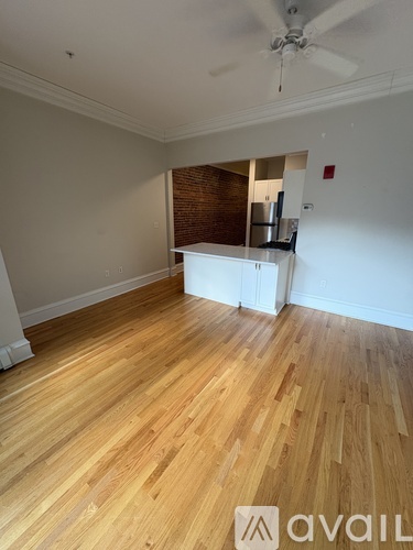 A room with wooden flooring and a ceiling fan.