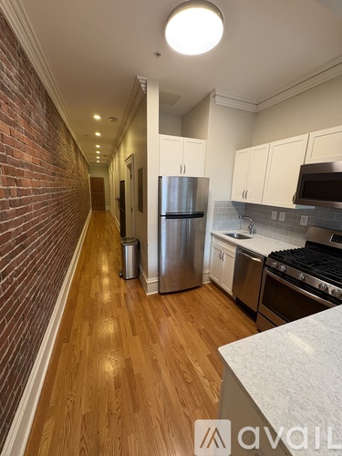 A kitchen with a refrigerator, stove, and oven.