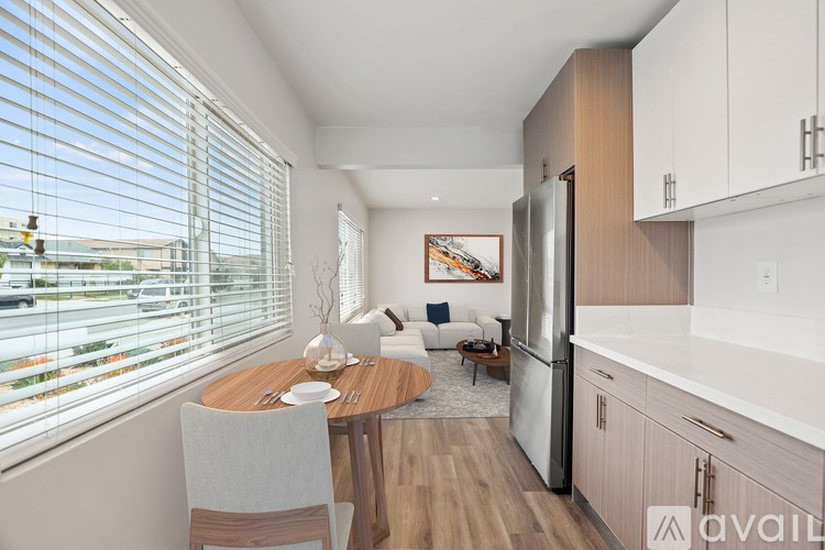 A modern kitchen with a dining table and chairs.