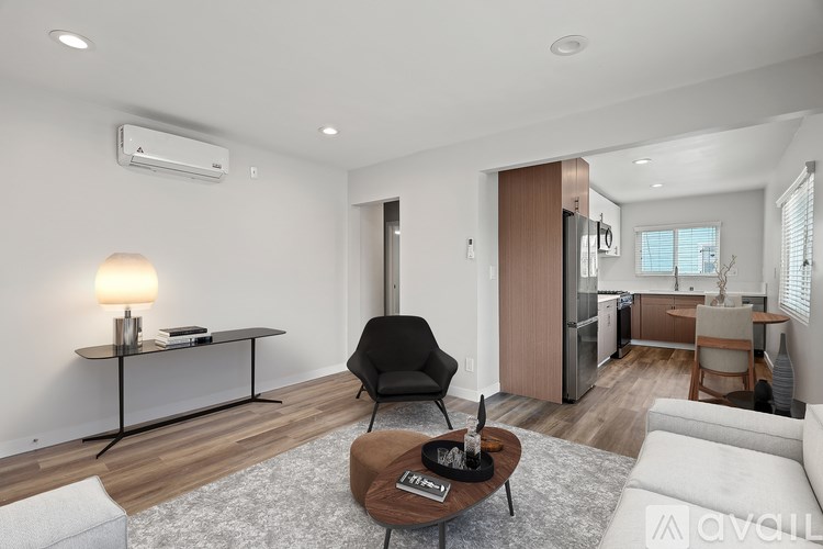 A modern living room with a black chair and a coffee table.