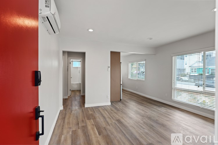 A modern house with a wooden exterior and a white fence.