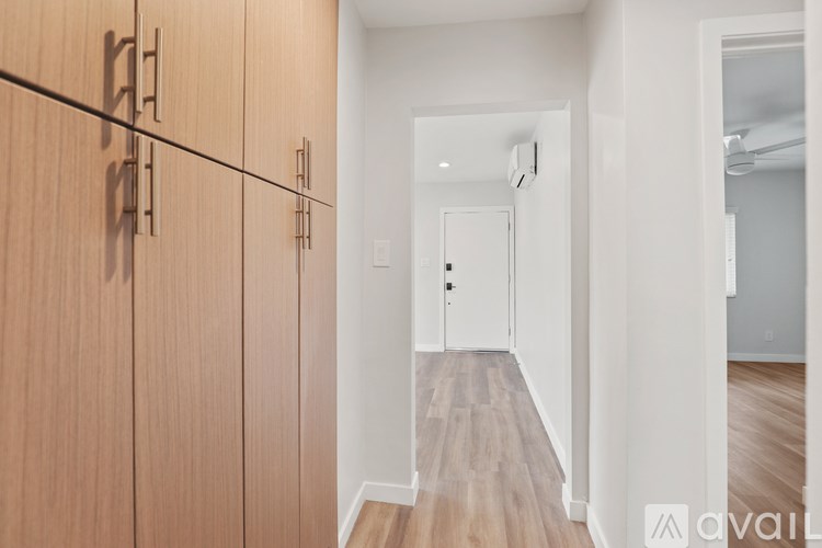 A two-story house with a balcony and stairs leading to the upper level.