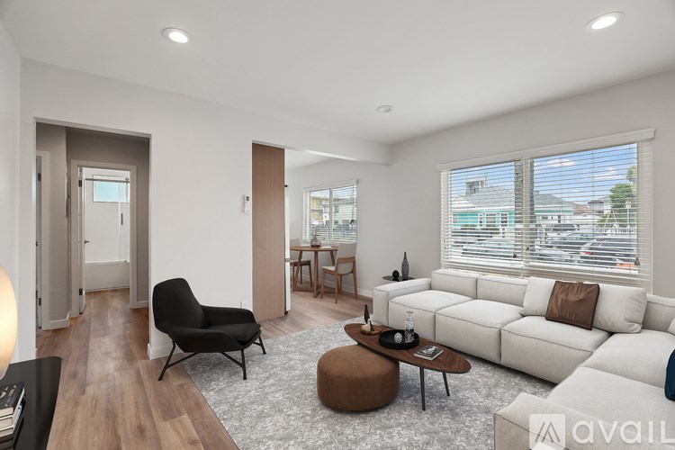 A modern living room with a black chair and a white sofa.