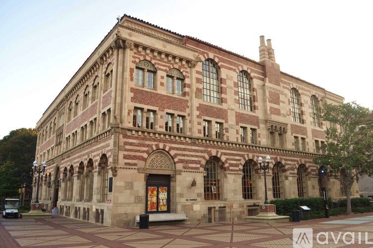 A large, ornate building with a red and beige facade.