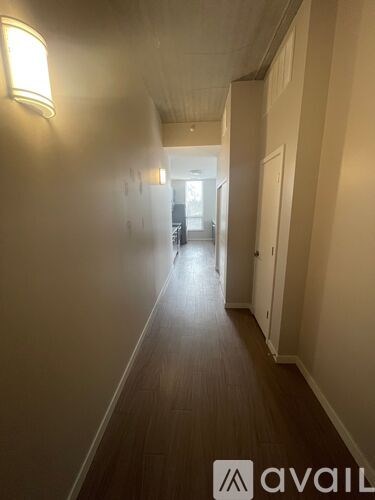 A long hallway with a light on the wall and a logo that says "avail".