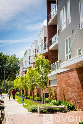 A modern apartment building with a brick facade and balconies.