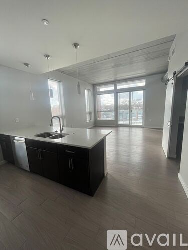A kitchen with black cabinets and a white countertop.