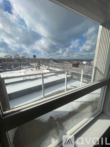 A view from a window looking out to a snowy landscape.