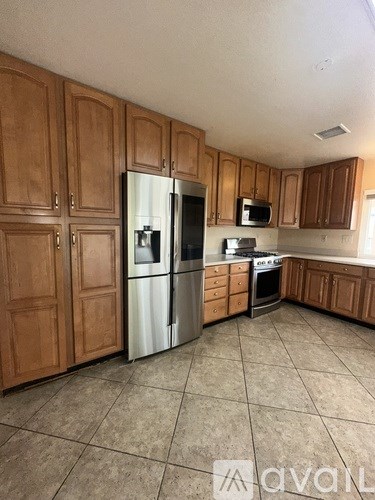 A kitchen with wooden cabinets and a white refrigerator.