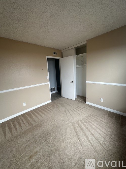 A patio with a sliding glass door and a mat on the floor.