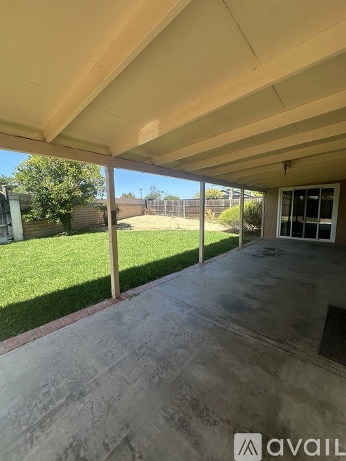 A room with a carpeted floor and a window.