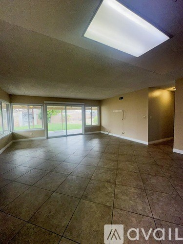 A room with tiled flooring and a skylight.