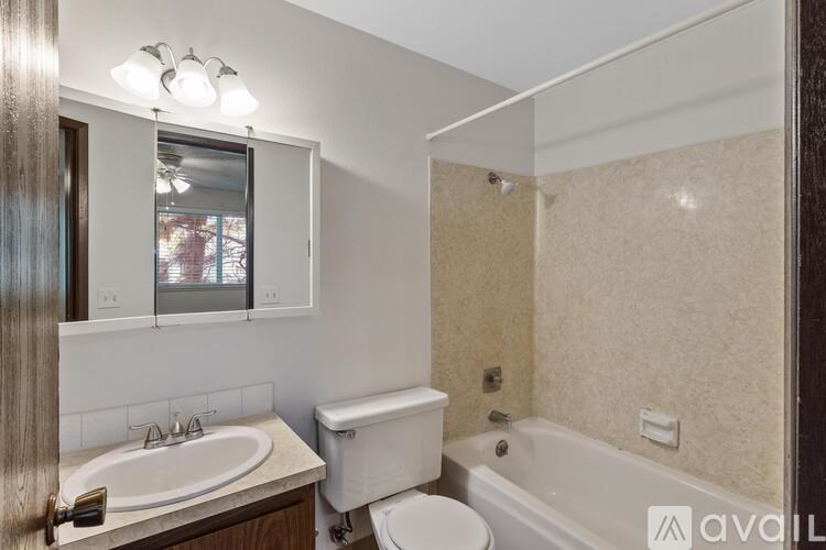 A bathroom with a toilet, sink, and bathtub.