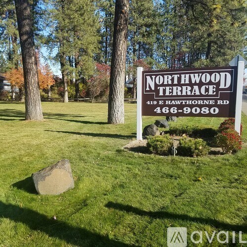 A sign for Northwood Terrace stands in a grassy area with trees in the background.