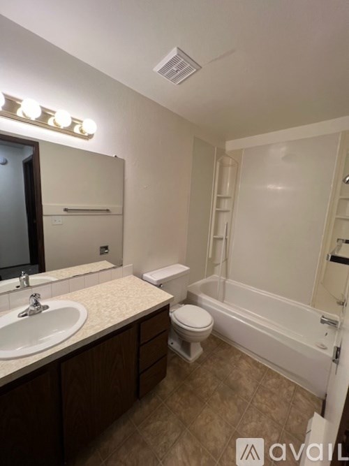 A bathroom with a sink, toilet, and bathtub.