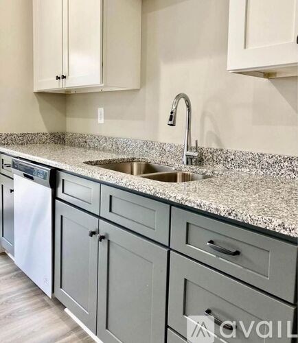 A kitchen with a sink and cabinets.