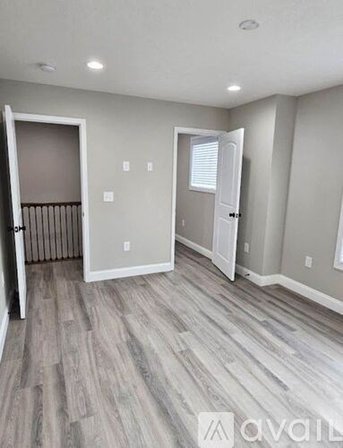 A room with a wooden floor and white walls.