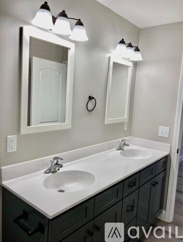 A bathroom with a white sink and a mirror above it.