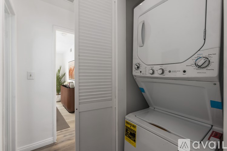 A white dryer is sitting in a small room.