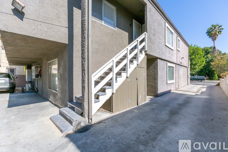 A concrete building with a staircase leading to the entrance.