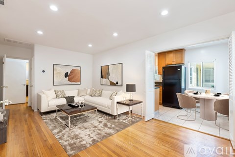 A living room with a white couch and a coffee table.