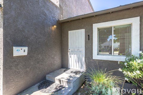 A house number 1 with a white door and window.