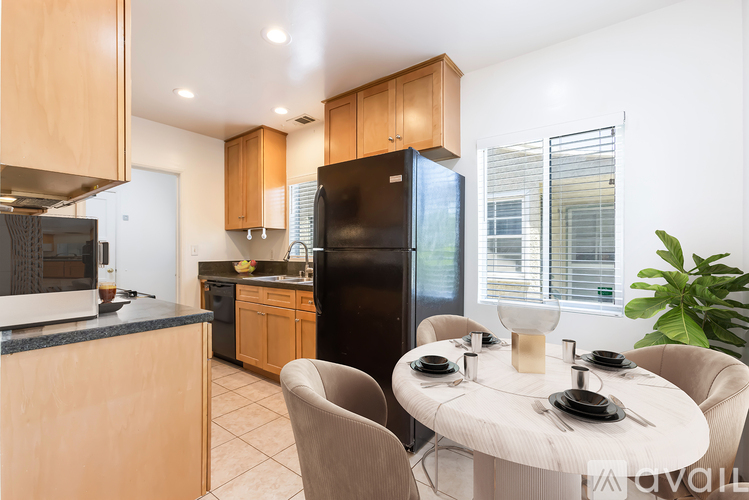 A kitchen with a table set for two.