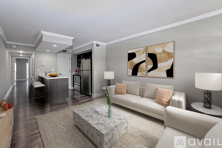 A modern living room with a white sofa and a marble coffee table.