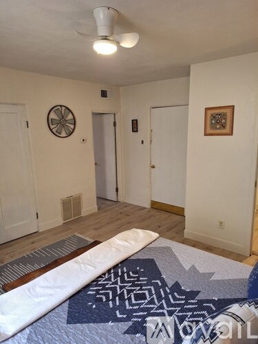 A white door with a light switch on the wall.